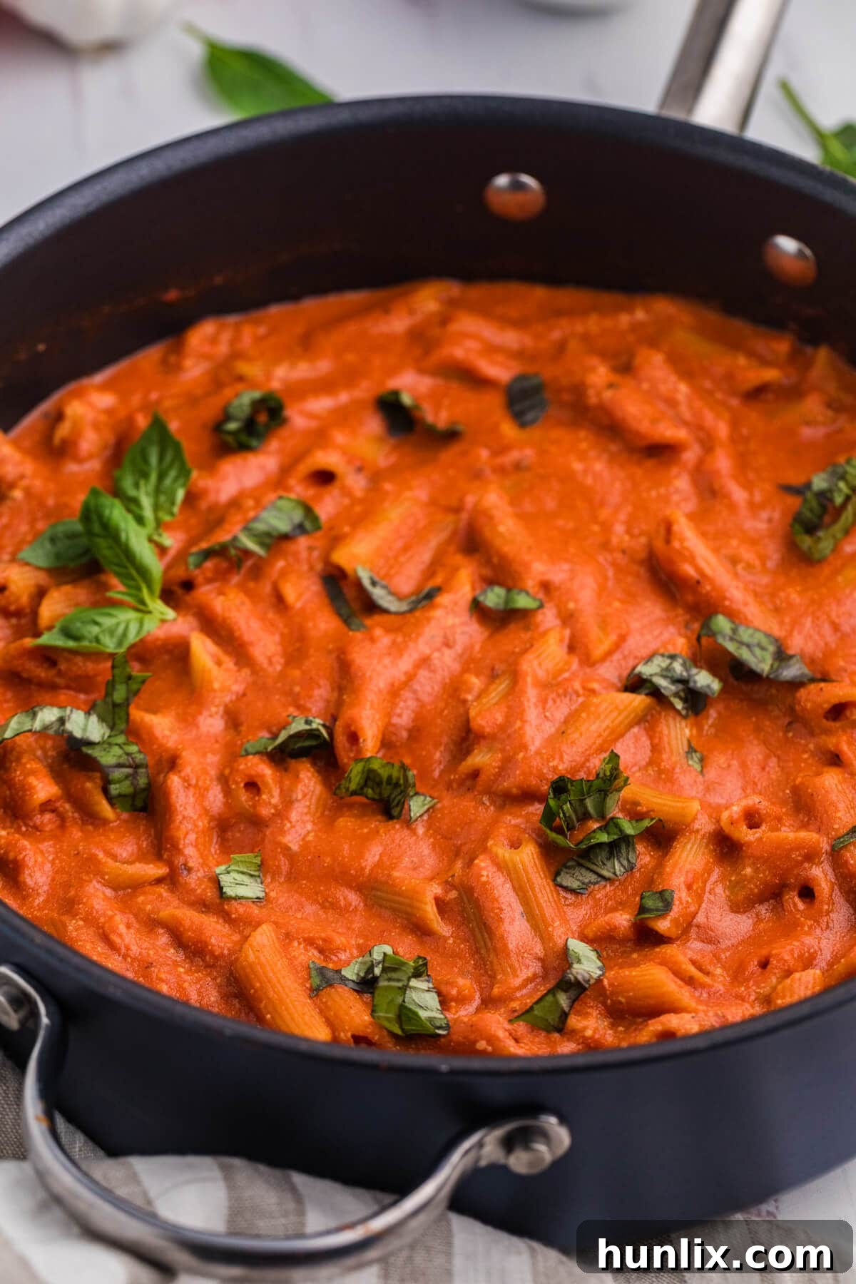 The finished One-Pot Creamy Tomato Pasta served in a rustic skillet, garnished with fresh basil, ready to be enjoyed.