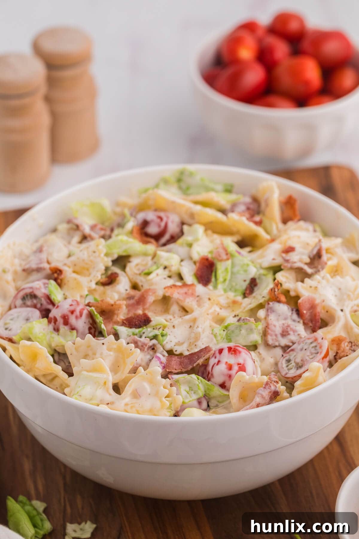 The BLT pasta salad in a white bowl, ready to serve.