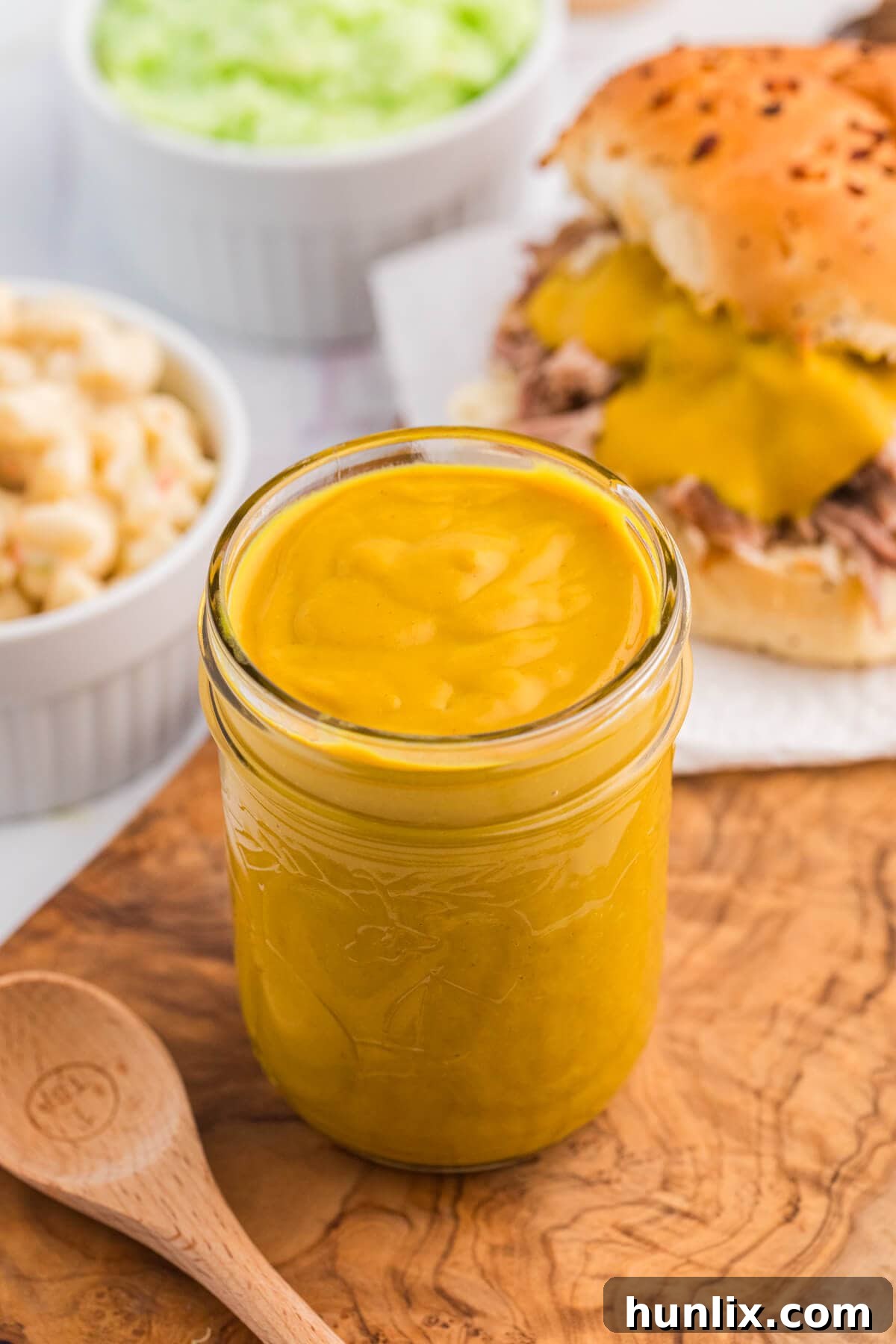 Carolina Mustard BBQ Sauce in a glass jar, showcasing its rich, golden color.