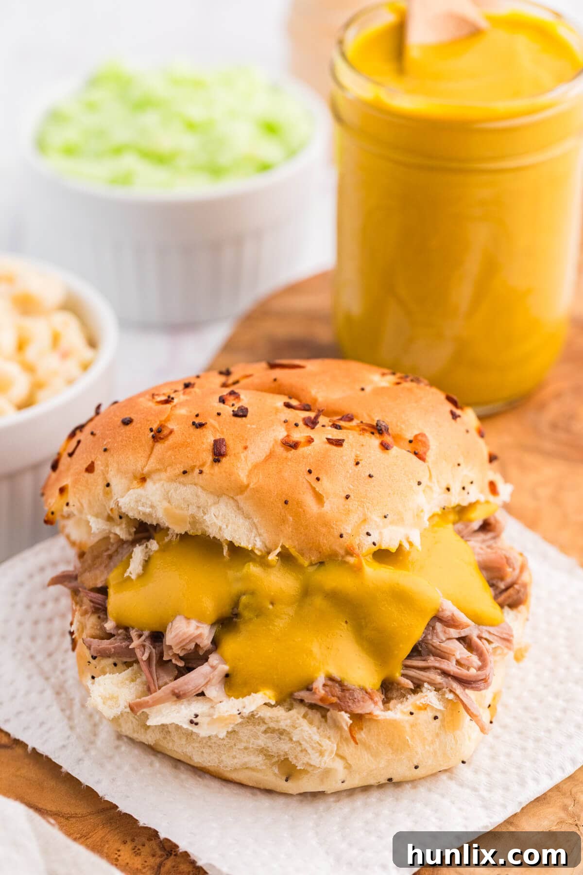 Delicious Carolina Mustard BBQ Sauce slathered generously on a bun with pulled pork, ready to be enjoyed.
