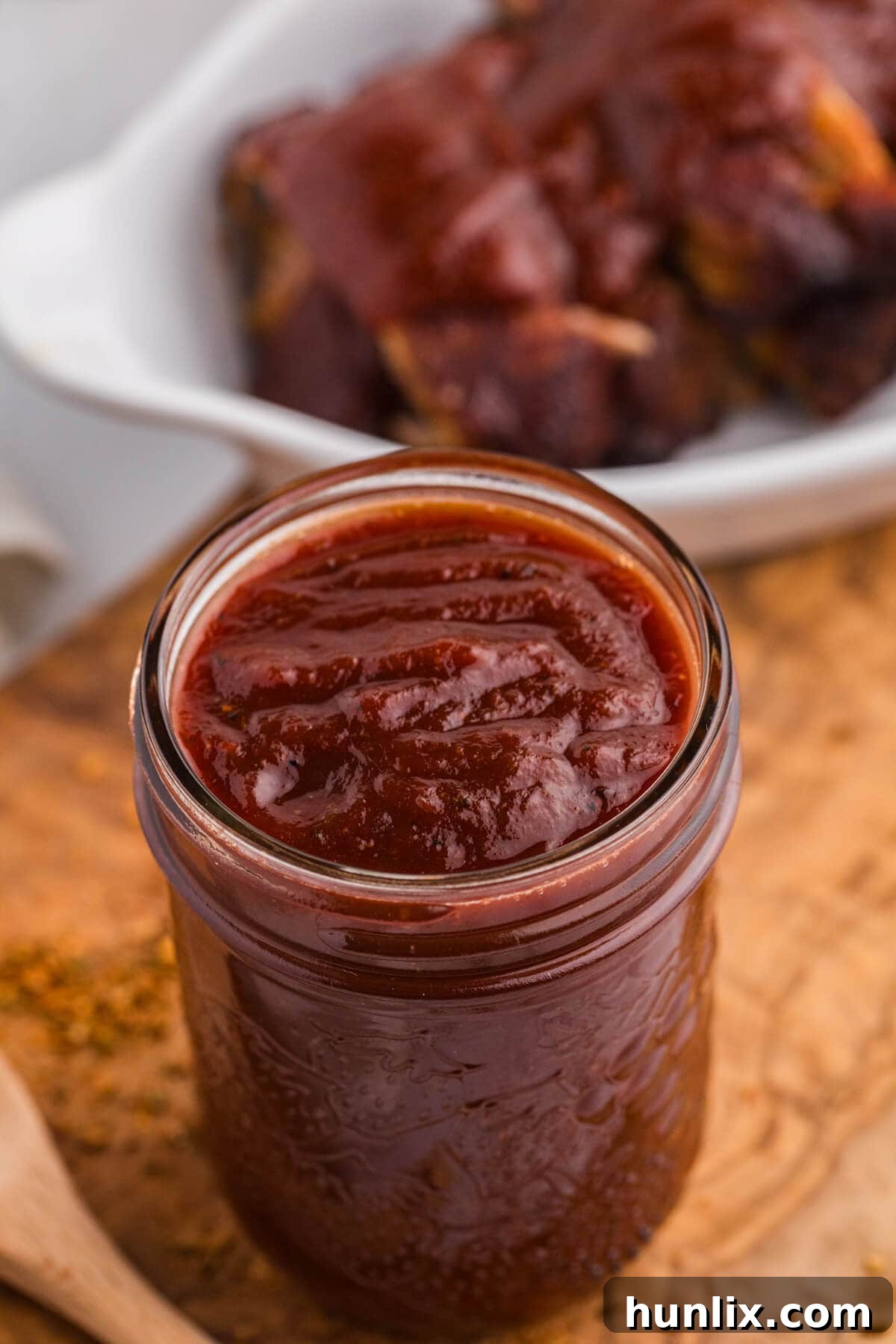 Cajun BBQ Sauce in a rustic glass jar, ready for use.