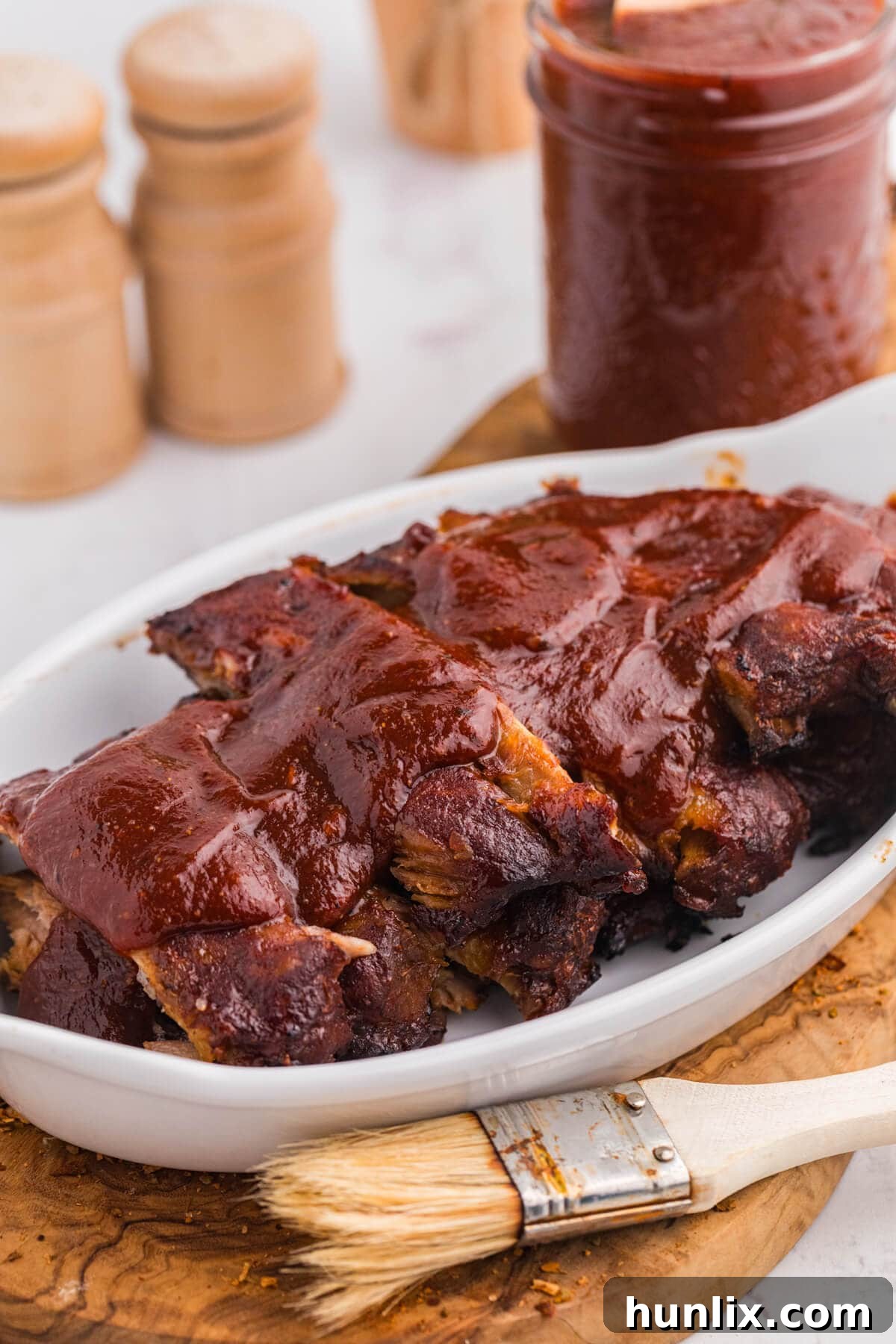A platter of succulent ribs generously coated with homemade Cajun BBQ Sauce.