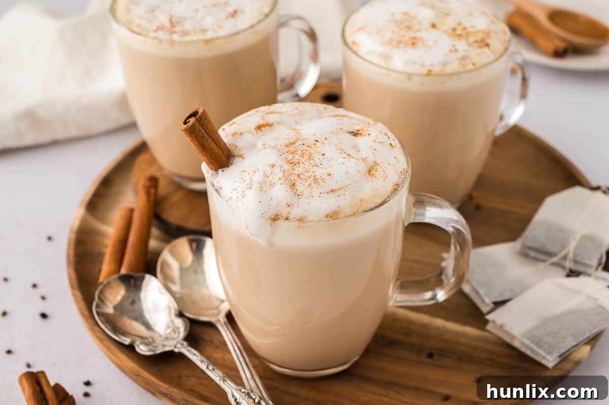Sip Your Way to Cozy Autumn Bliss 5 A glass mug filled with Slow Cooker Chai Latte, garnished with spices.