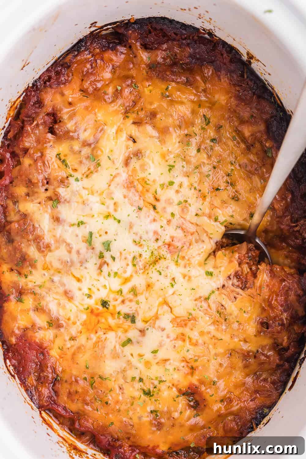 Slow Cooker Ravioli Lasagna, a cheesy and hearty lazy lasagna with frozen ravioli and homemade tomato sauce.