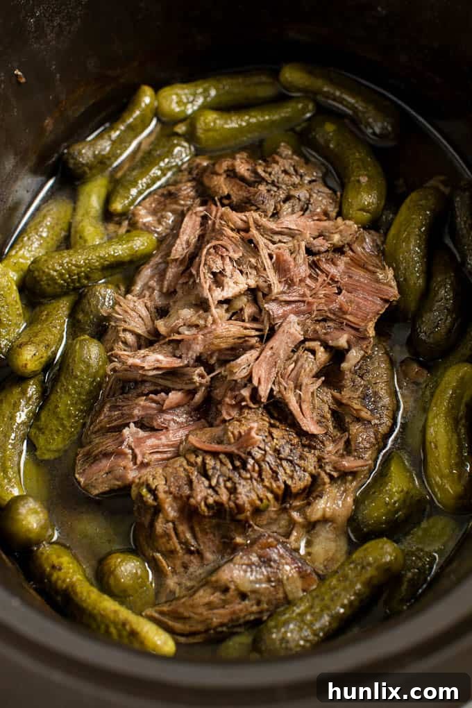 Dill Pickle Roast Beef - This might be the most simple slow cooker recipe ever! Dump a jar of pickles in a slow cooker with your preferred cut of beef. You'll be amazed in 8 hours!