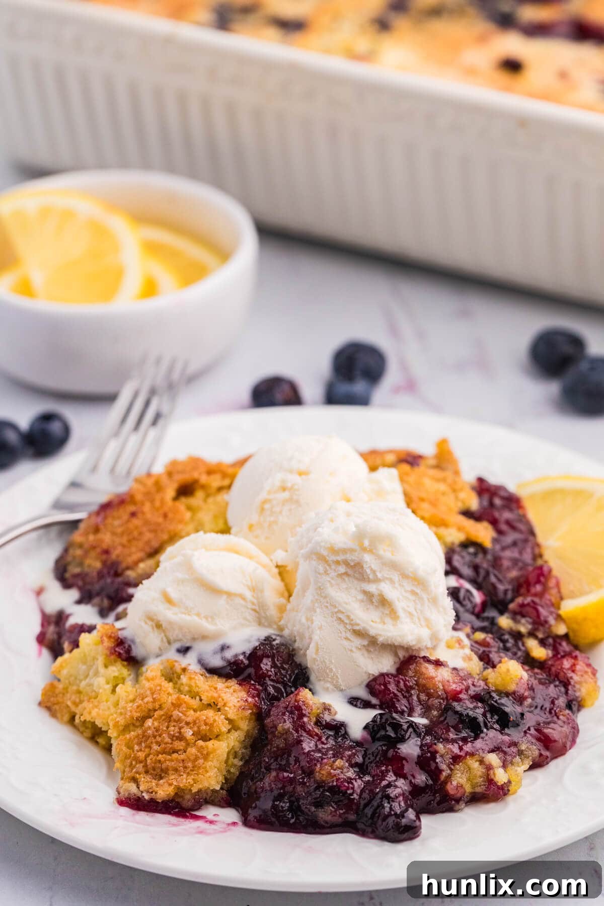 The recipe on a plate topped with vanilla ice cream.