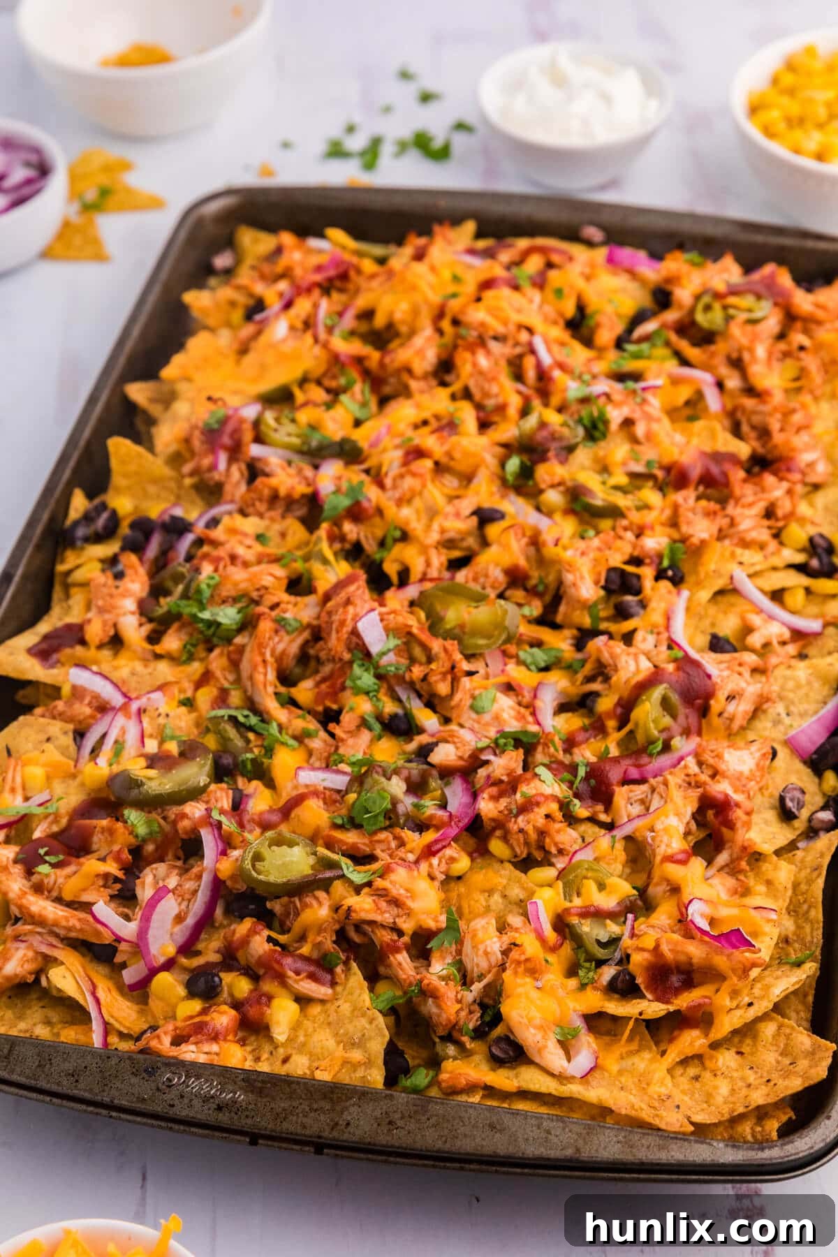 The recipe on a sheet pan loaded with toppings.