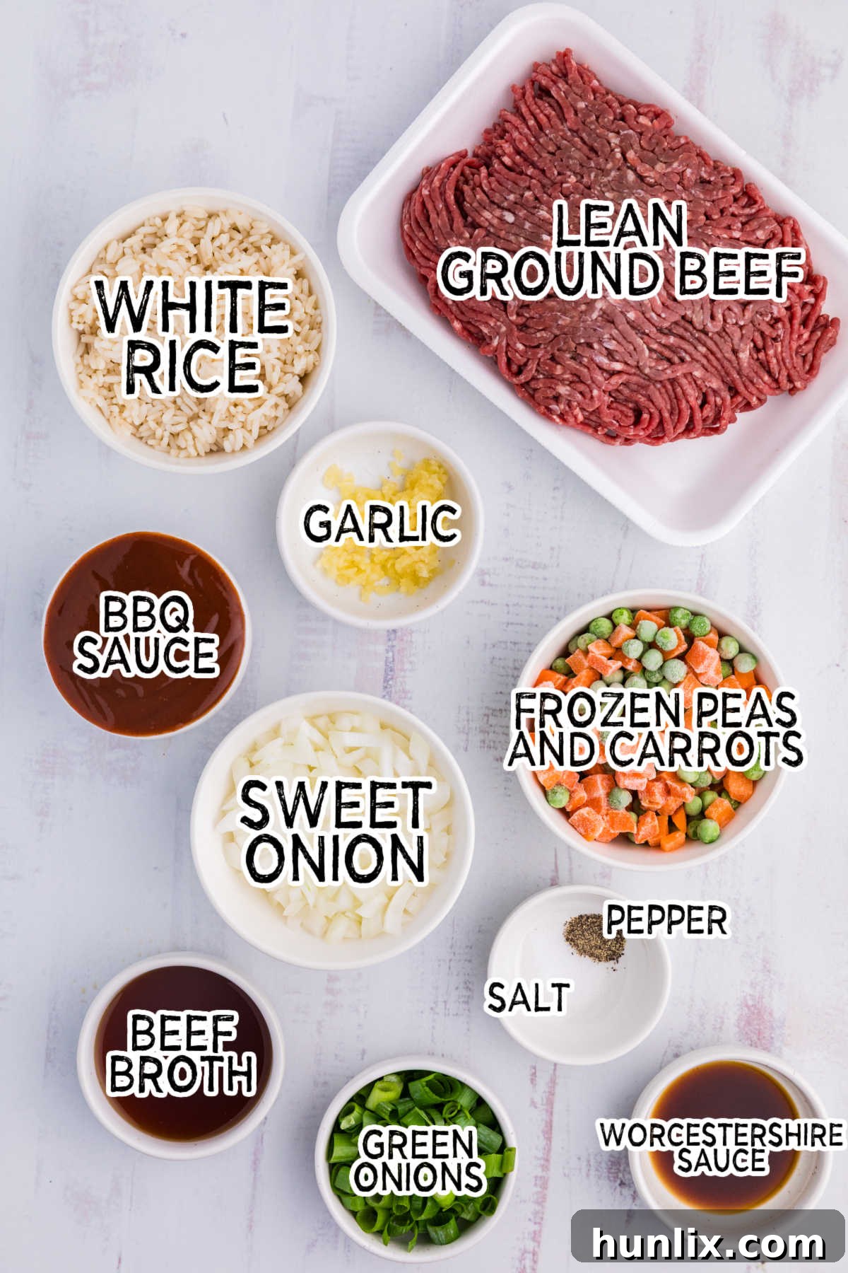 Easy Skillet BBQ Beef and Rice 3 Various fresh ingredients laid out on a white surface, ready for cooking.