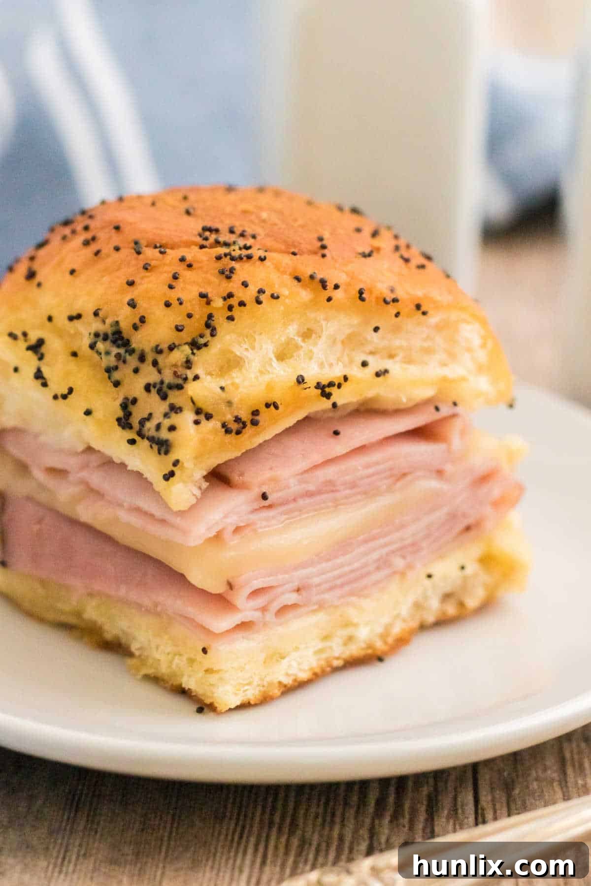 Mouthwatering ham and cheese sliders with a savory butter sauce.