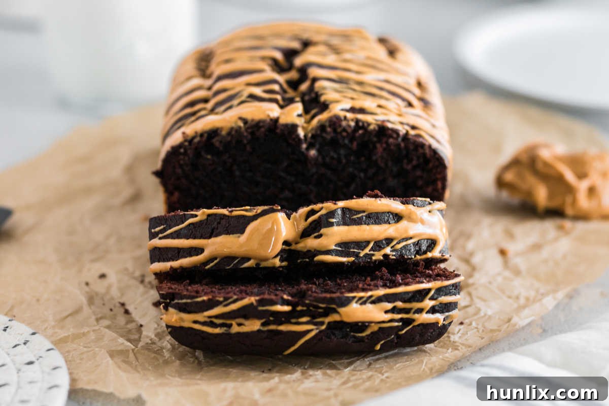 A loaf of decadent Chocolate Peanut Butter Banana Bread, showing its rich texture.