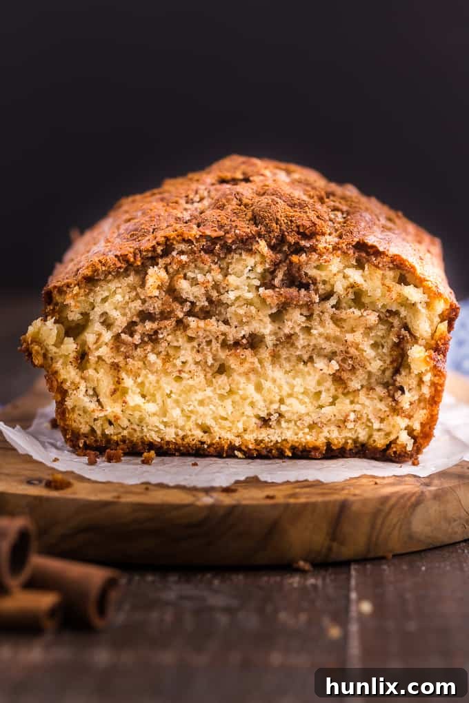 A perfectly baked Cinnamon Bread loaf, showing swirls of cinnamon sugar.