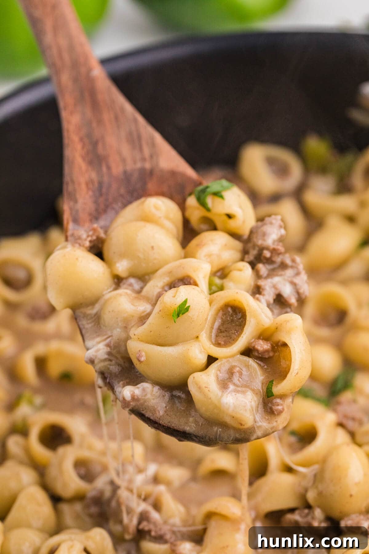 Cheesesteak Noodle Skillet 6 Philly Cheesesteak Pasta served on a wooden serving spoon.
