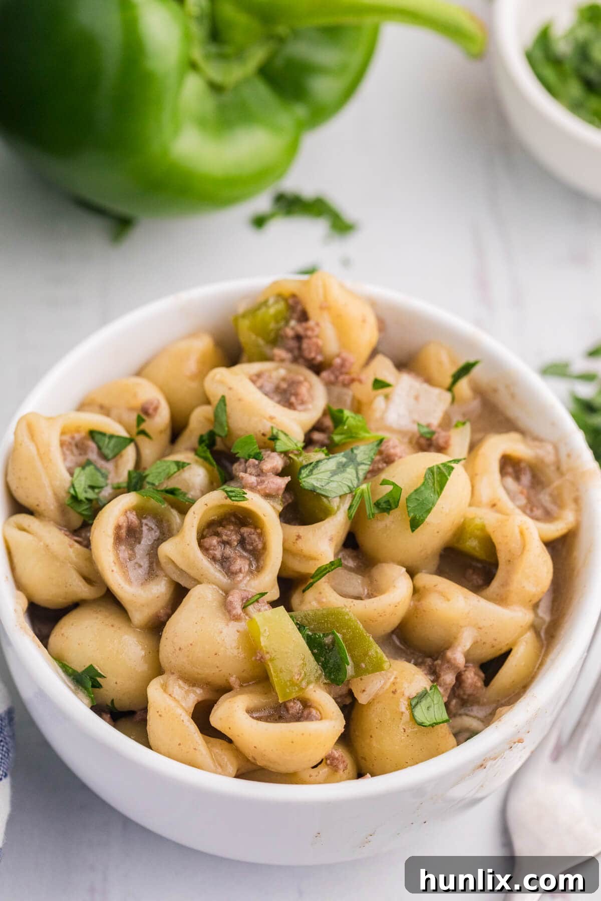 Cheesesteak Noodle Skillet 7 Philly Cheesesteak Pasta served in a white bowl, ready to eat.