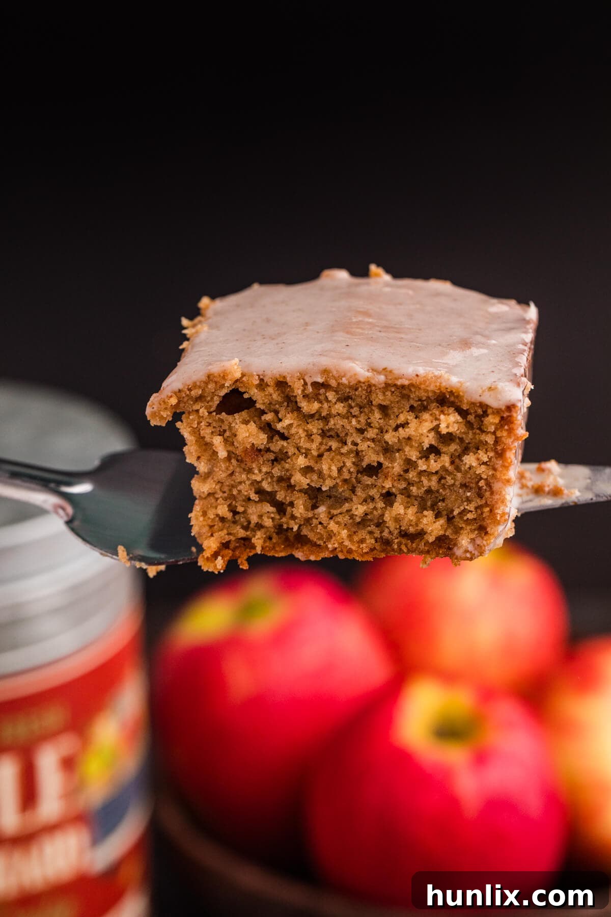 A piece of Apple Butter Cake being lifted out of the pan with a spatula, revealing its soft bottom.