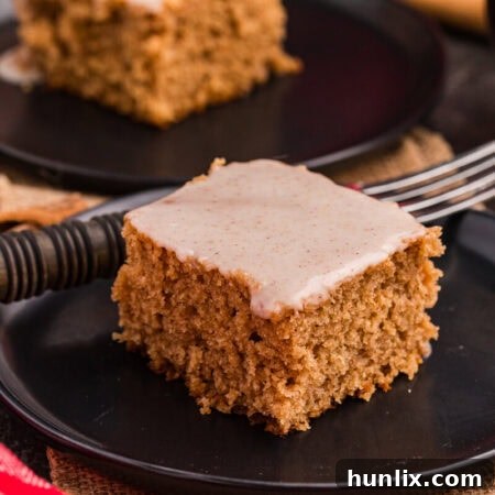 A piece of cake on a plate, garnished.