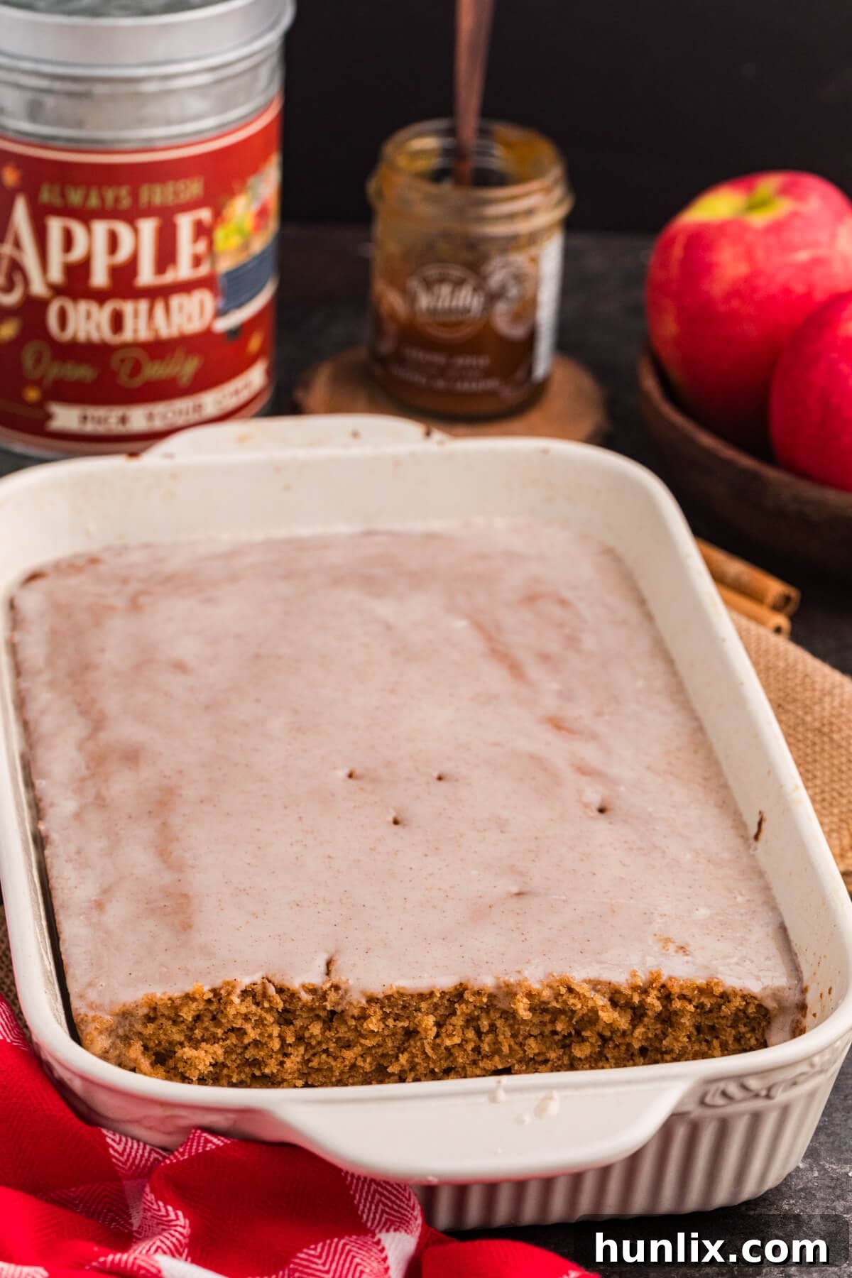 The baked Apple Butter Cake in a pan with several slices already cut out, revealing its moist interior.
