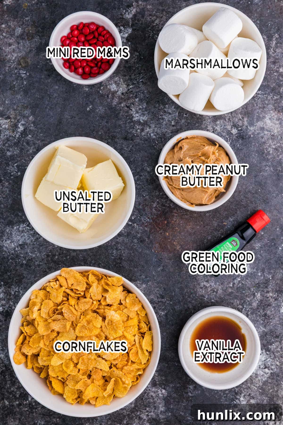 Crispy Cereal Wreaths 3 Ingredients on a dark background, including butter, marshmallows, peanut butter, vanilla, cornflakes, and food coloring.