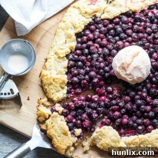 Buttery Saskatoon Berry Galette with fresh lemon and thyme for a delicate flavor.