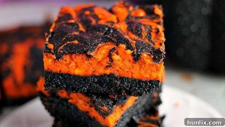 Halloween Swirl Cream Cheese Brownies with orange cheesecake swirls.