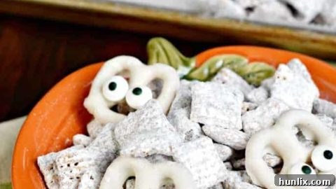 Classic puppy chow recipe transformed into Halloween Muddy Buddies with white chocolate mummies.