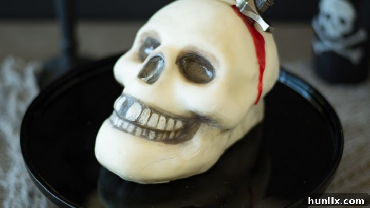 Halloween Skull and Dagger Cake, a fun and spooky centerpiece.