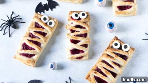 Easy 3-ingredient Halloween mummy pies with raspberry filling.