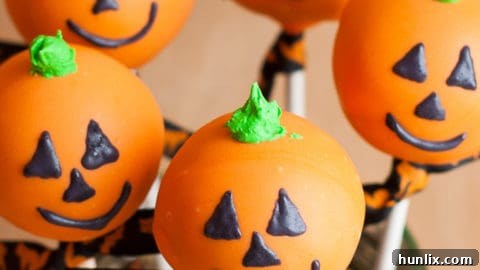 Delicious Halloween cake pops decorated like Jack O' Lanterns.