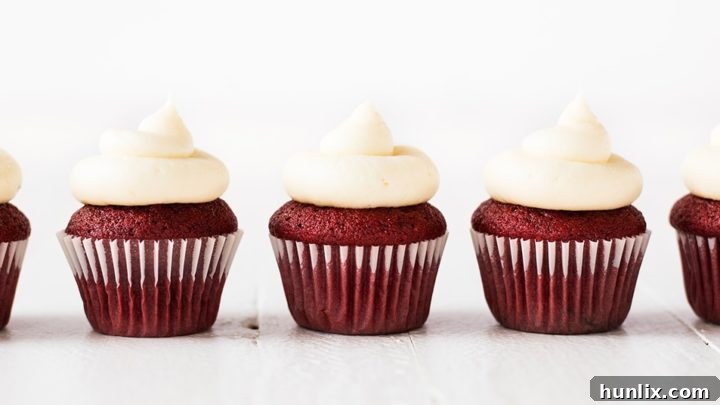 Bite-sized Mini Red Velvet Cupcakes, perfectly topped with a rich and creamy cream cheese frosting for a delightful treat.