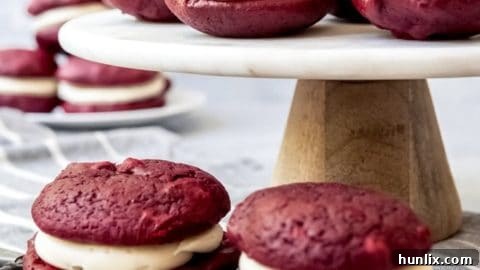 Easy Homemade Red Velvet Whoopie Pies with light cocoa flavor and creamy cream cheese frosting, a tasty handheld treat.