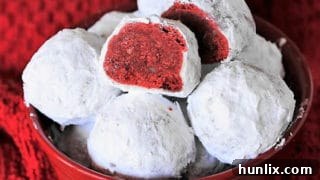 Red Velvet Snowball Cookies, a fun twist on the classic, with chocolate flavor and a deep red interior, perfect for any cookie jar.