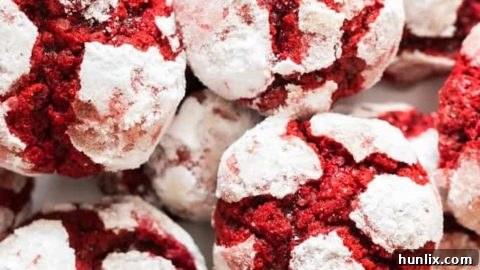 Deliciously soft, thick, cakey, and buttery Red Velvet Crinkle Cookies, perfect for any celebration, with a crispy exterior and chewy, cake-like interior.
