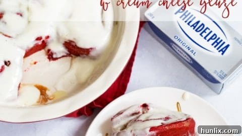 Creamy Red Velvet Cinnamon Rolls with a luscious cream cheese glaze, featuring a delicious brown sugar and cinnamon swirl.