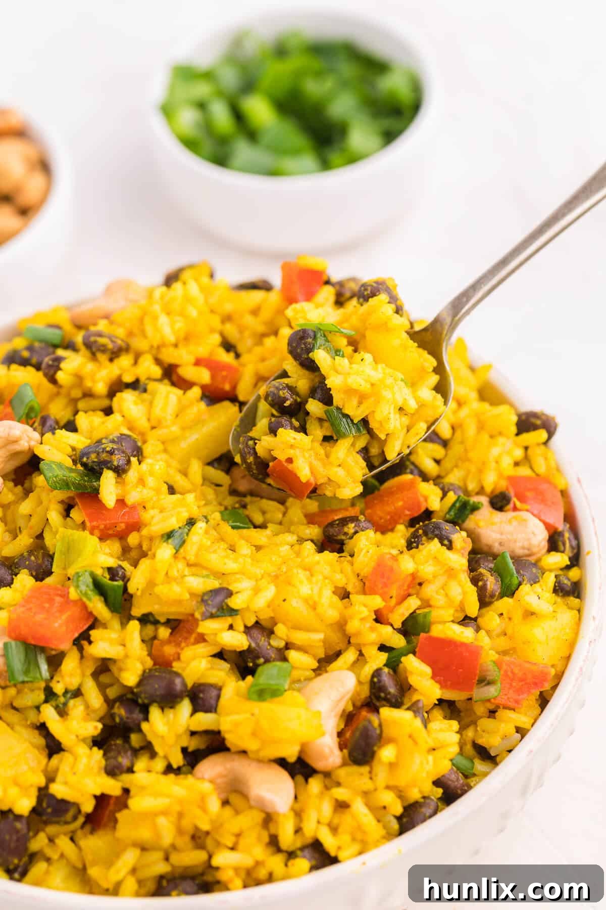 Jamaican Curry Rice 5 A spoon nestled in a bowl of aromatic Jamaican Curried Rice, ready to be enjoyed.