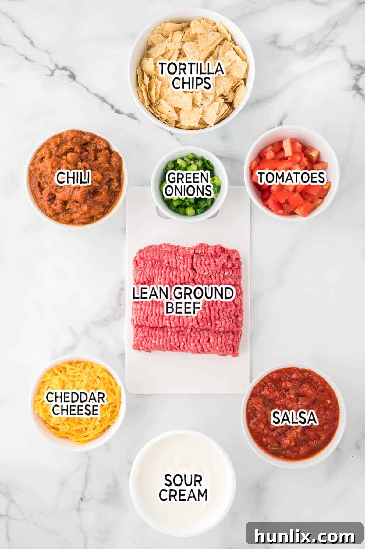 Ingredients for making taco casserole laid out on a surface.