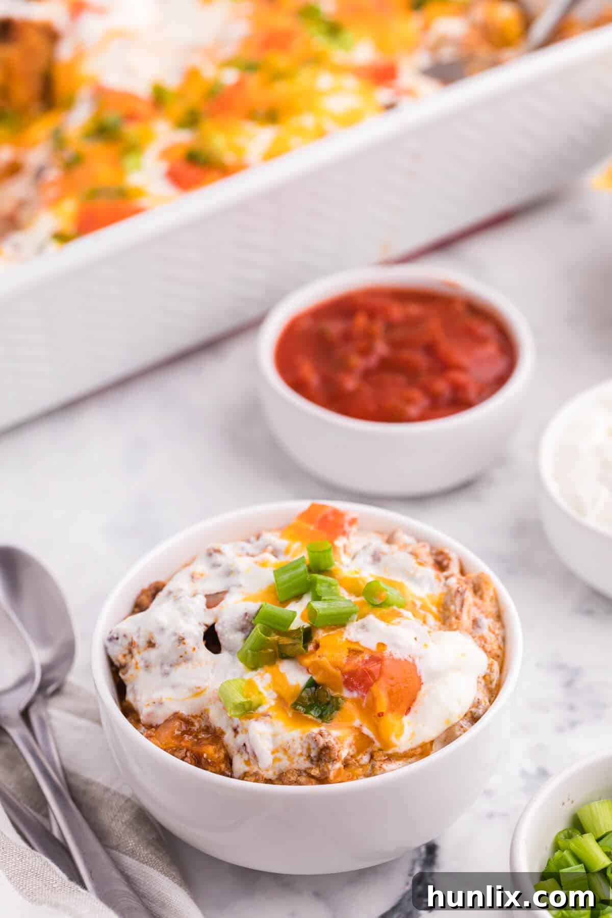 A bowl of taco casserole with a fork, ready to be enjoyed.