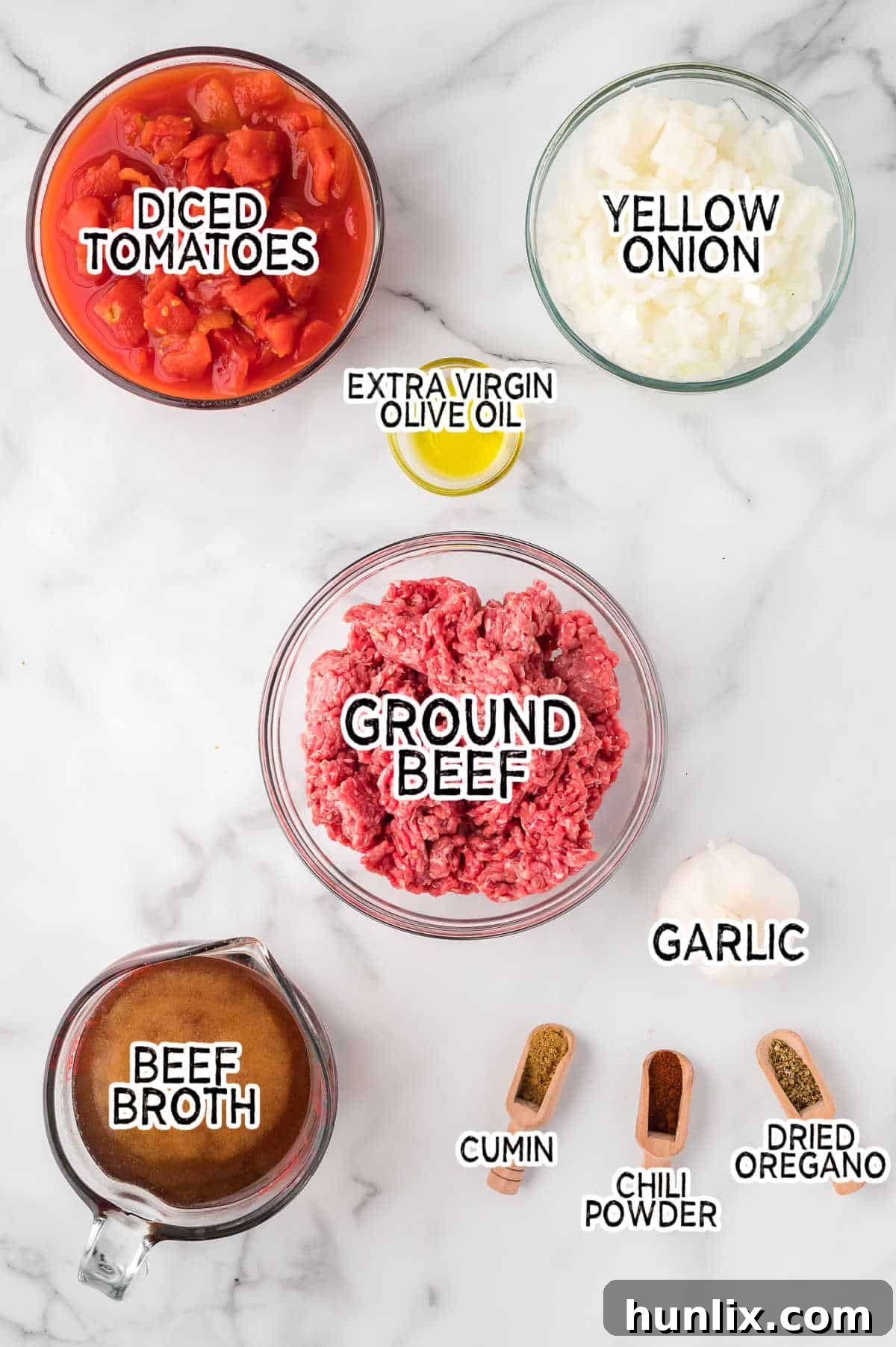 A selection of fresh ingredients laid out on a white marble counter, ready for preparing taco soup.
