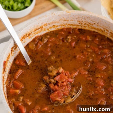 The soup in a pot with a ladle, illustrating a delicious serving of Taco Soup.