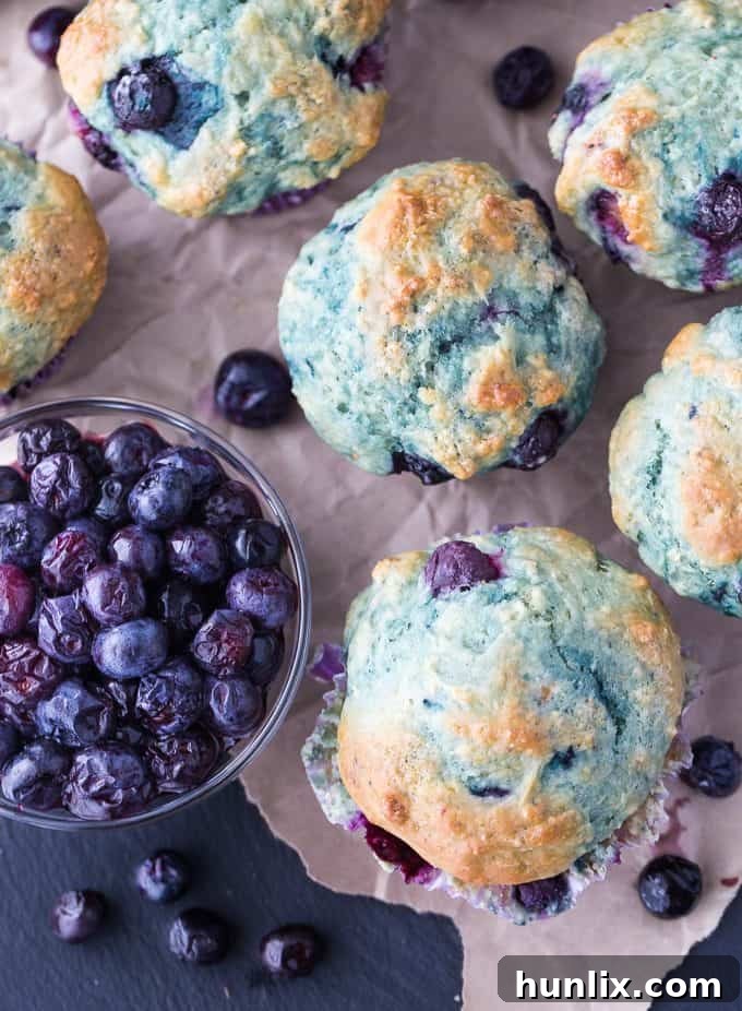 A basket full of golden-brown Blueberry Yogurt Muffins, ready to be served.