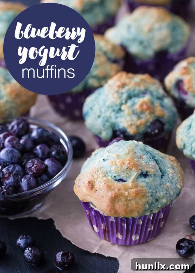 A stack of golden Blueberry Yogurt Muffins, highlighting their fluffy texture.