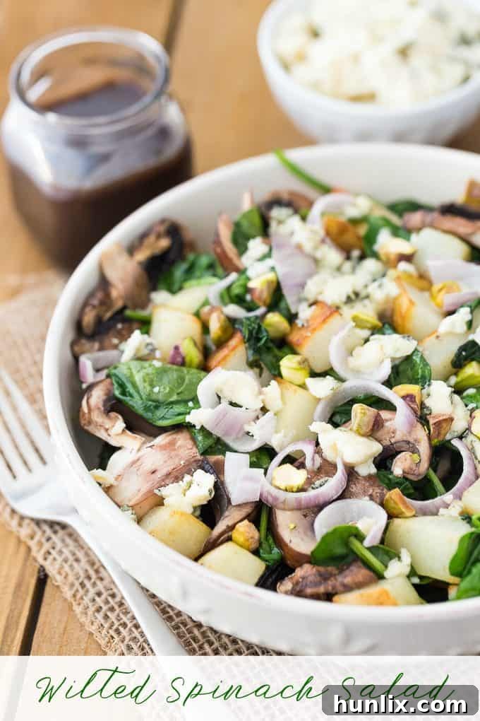 Wilted Spinach Salad - Crimini Mushrooms and Crispy Potato are topped on a bed of wilted spinach drenched with a raspberry balsamic dressing.