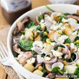 Wilted Spinach Salad with Crimini Mushrooms, Crispy Potatoes, and Raspberry Balsamic Dressing
