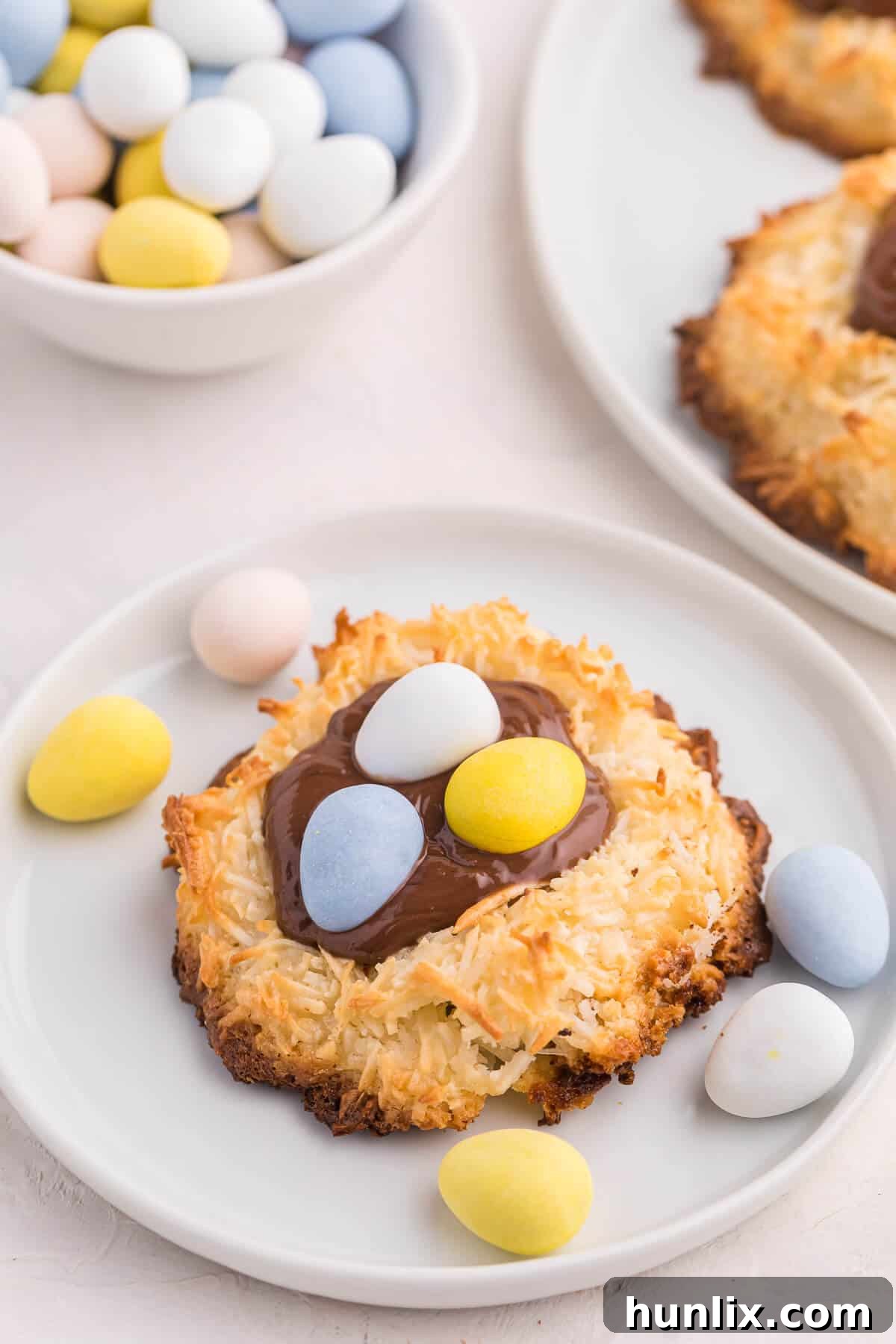 A single Coconut Macaroon Nutella Cookie Nest presented on a small ceramic plate, showcasing its festive appeal.