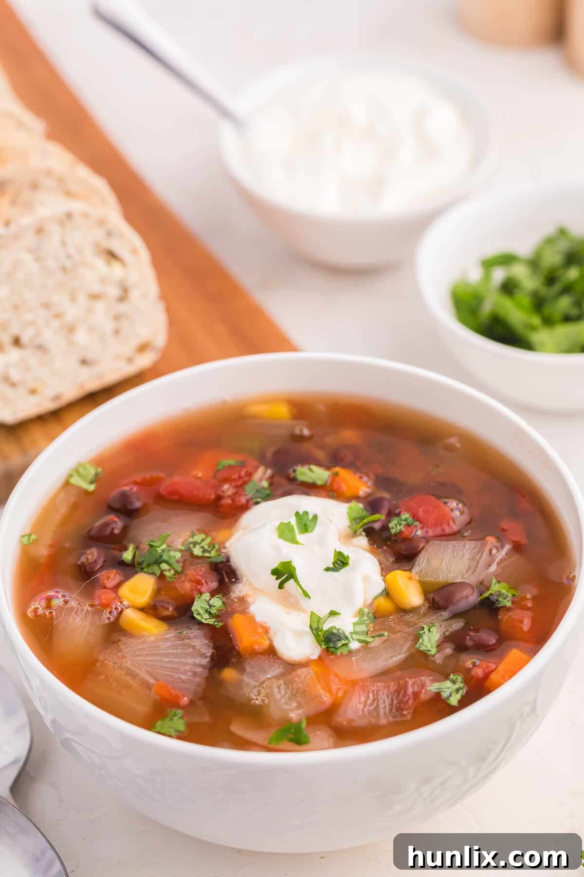 A large pot of Black Bean Vegetable Soup simmering on the stovetop, ready to be served.