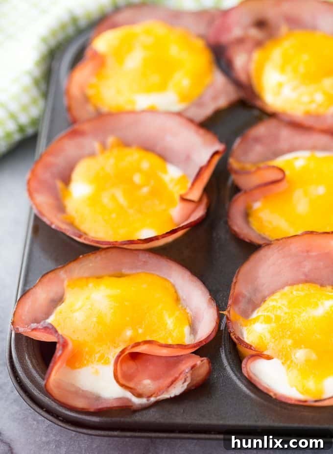Baked Ham and Egg Cups 2 Ham & Eggs in a Muffin Tin - Savory and filling, this low carb breakfast recipe is a great make-ahead option for busy mornings.