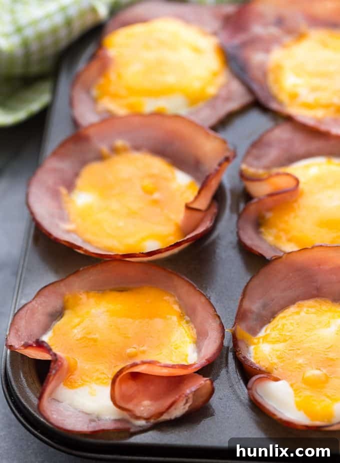 Baked Ham and Egg Cups 3 Ham & Eggs in a Muffin Tin - Savory and filling, this low carb breakfast recipe is a great make-ahead option for busy mornings.