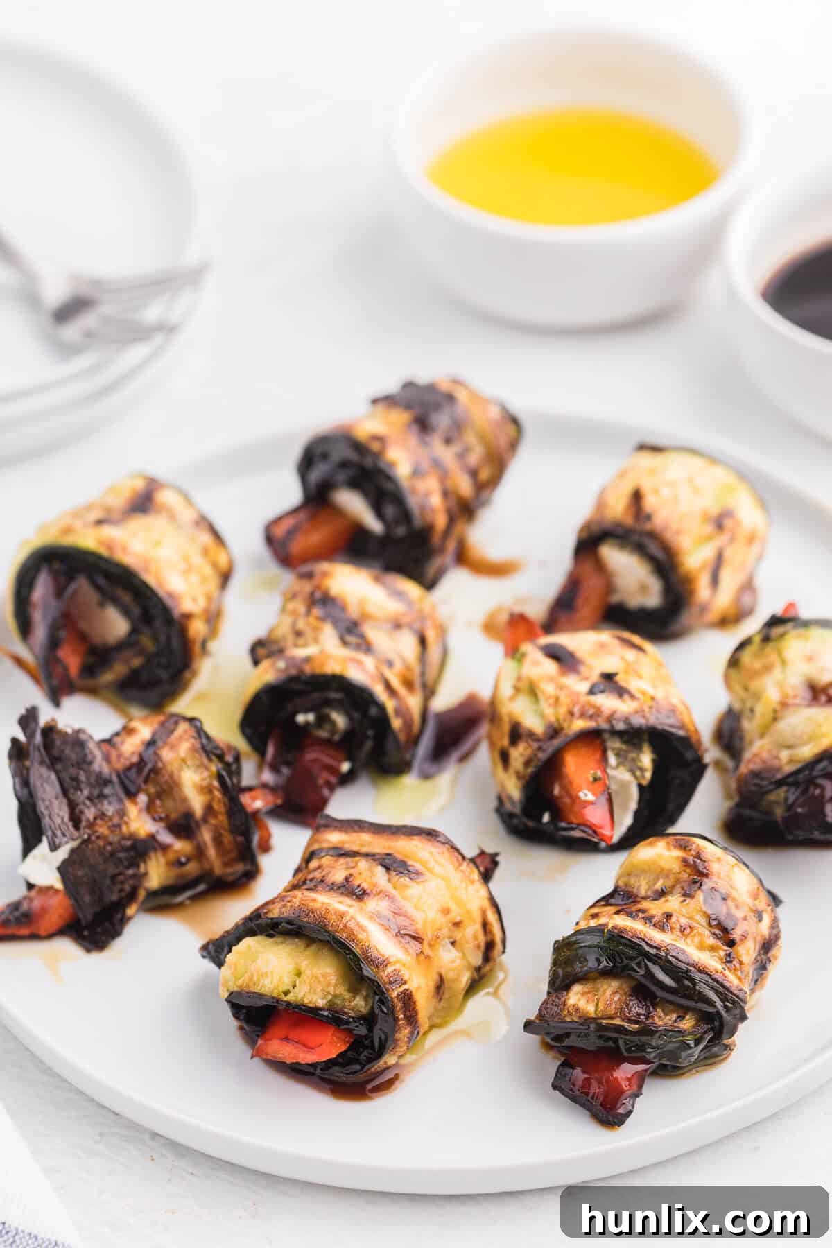 Delectable Grilled Zucchini Roll-Ups 3 Grilled Zucchini Roll-Ups - A simple, but savory summer appetizer. This easy recipe wraps grilled zucchini strips around herbed goat cheese and grilled red peppers with a finish of extra olive oil and balsamic vinegar. Mmm!