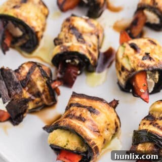 Grilled Zucchini Roll-Ups - A simple, but savory summer appetizer. This recipe wraps goat cheese with grilled veggies. Mmm!