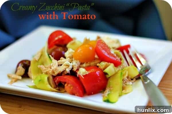 Creamy Zucchini "Pasta" with Tomato - Ditch the carbs with this keto-friendly recipe! These zoodles are fresh and light with tomatoes, shredded chicken, goat cheese, and balsamic vinegar. Perfect for cookouts.