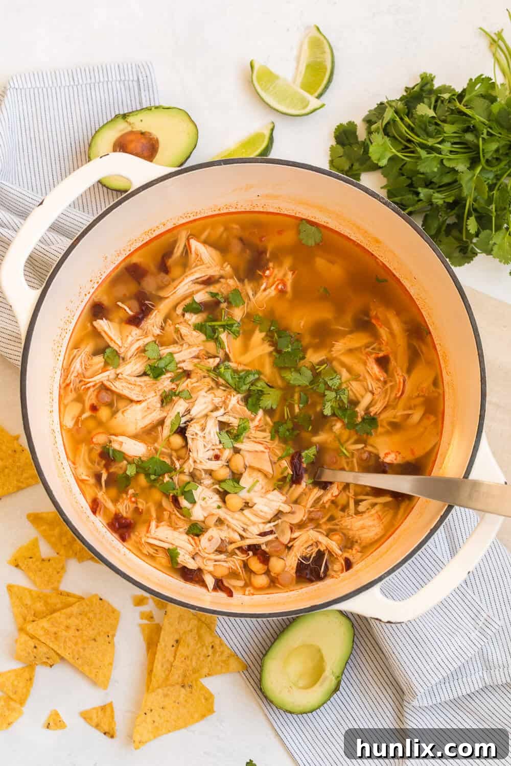 chipotle chicken soup in a soup pot with a ladle