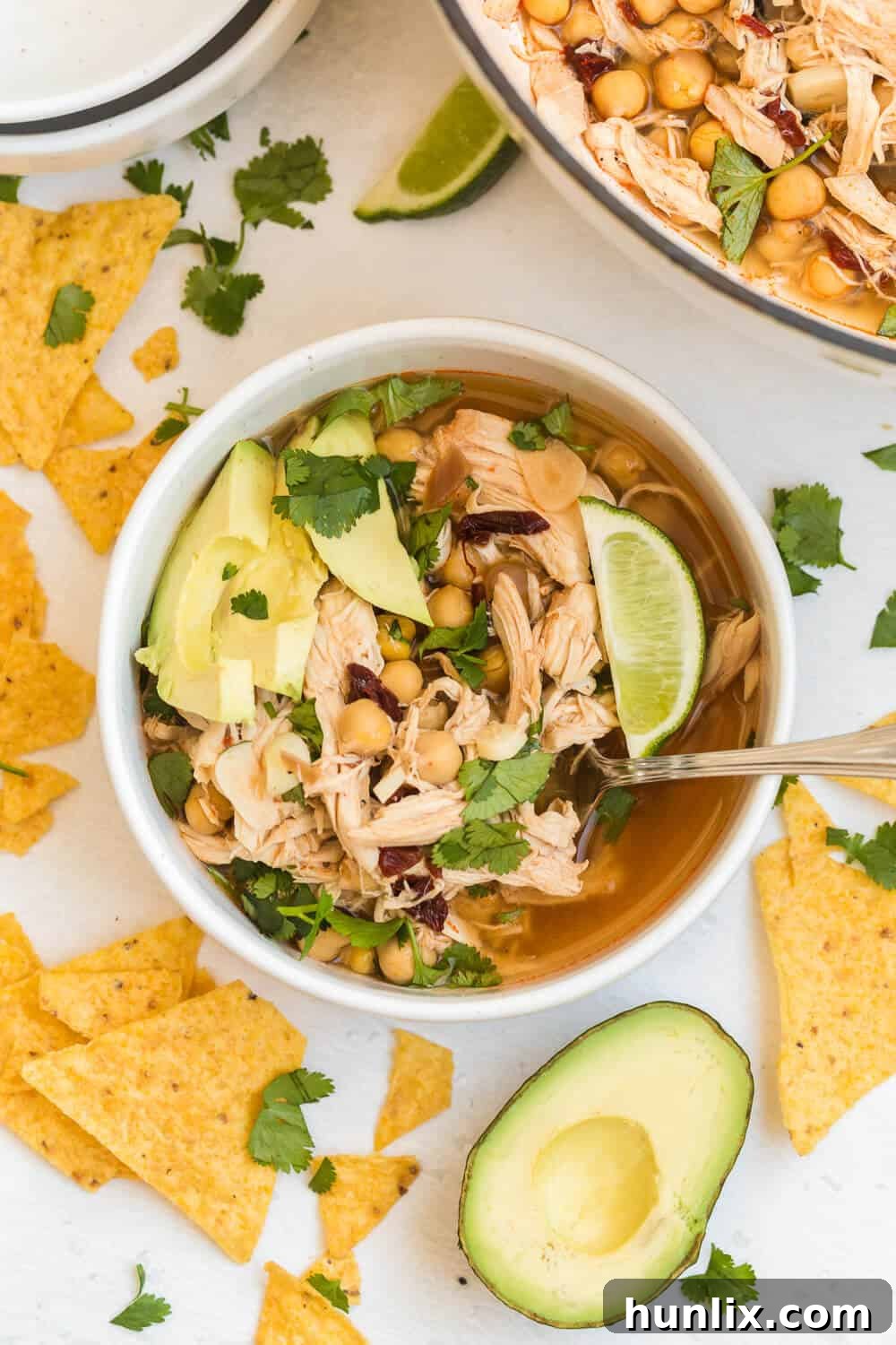chipotle chicken soup in a soup bowl with a spoon